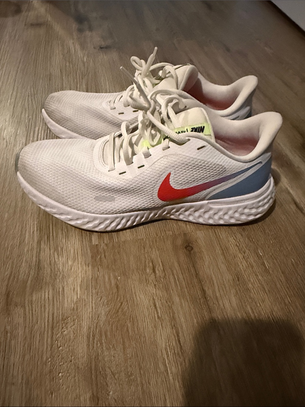 Nike Revolution Women’s White Running Shoes with pink Swoosh & Blue Heel accent